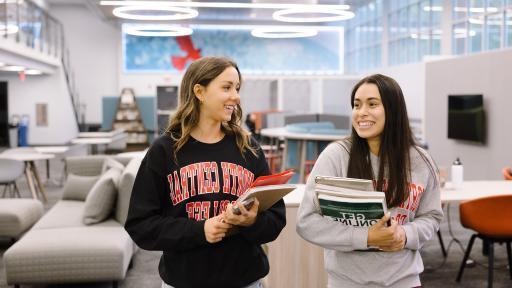 students walking in the library